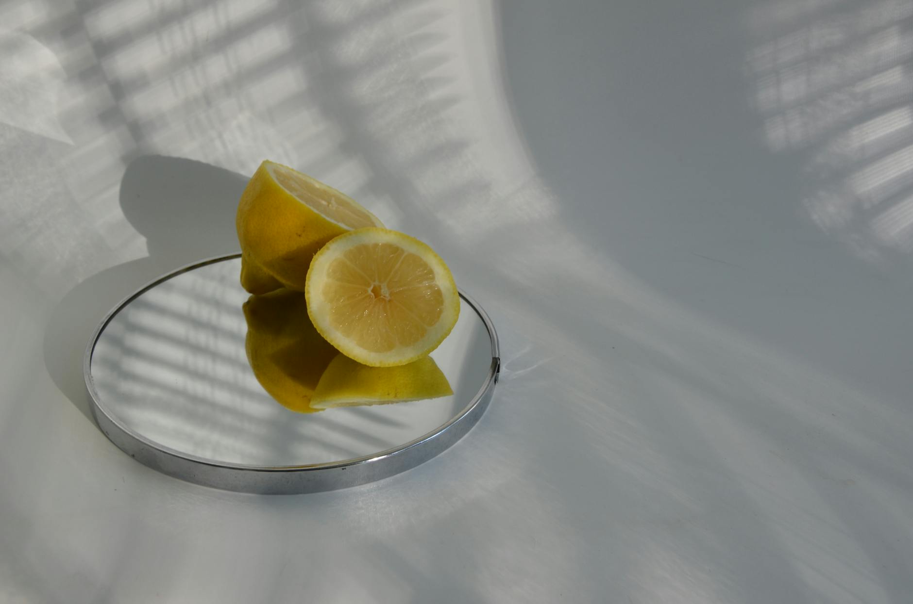 Bright yellow lemons arranged on a soft pastel background, symbolizing the Lemons Massager brand