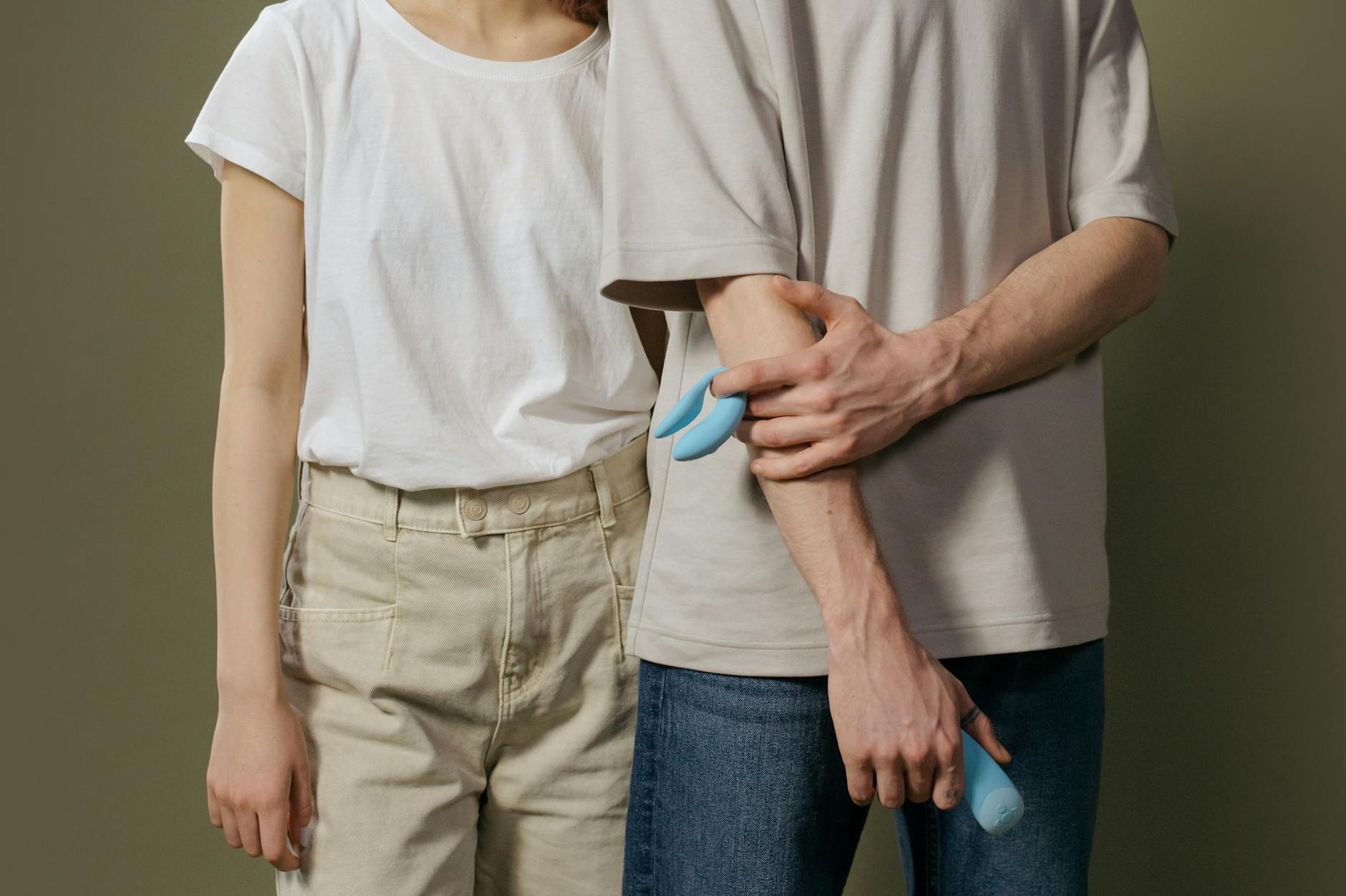 A hand holding a fresh lemon against a bright yellow background, symbolizing the fresh, innovative approach of lemon clitoral vibrators